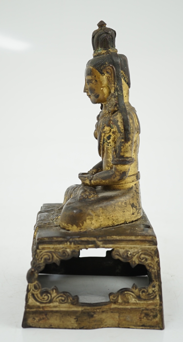 A Sino-Tibetan gilt repoussé copper alloy seated figure of Amitayus, Qianlong period, lacking aureole
